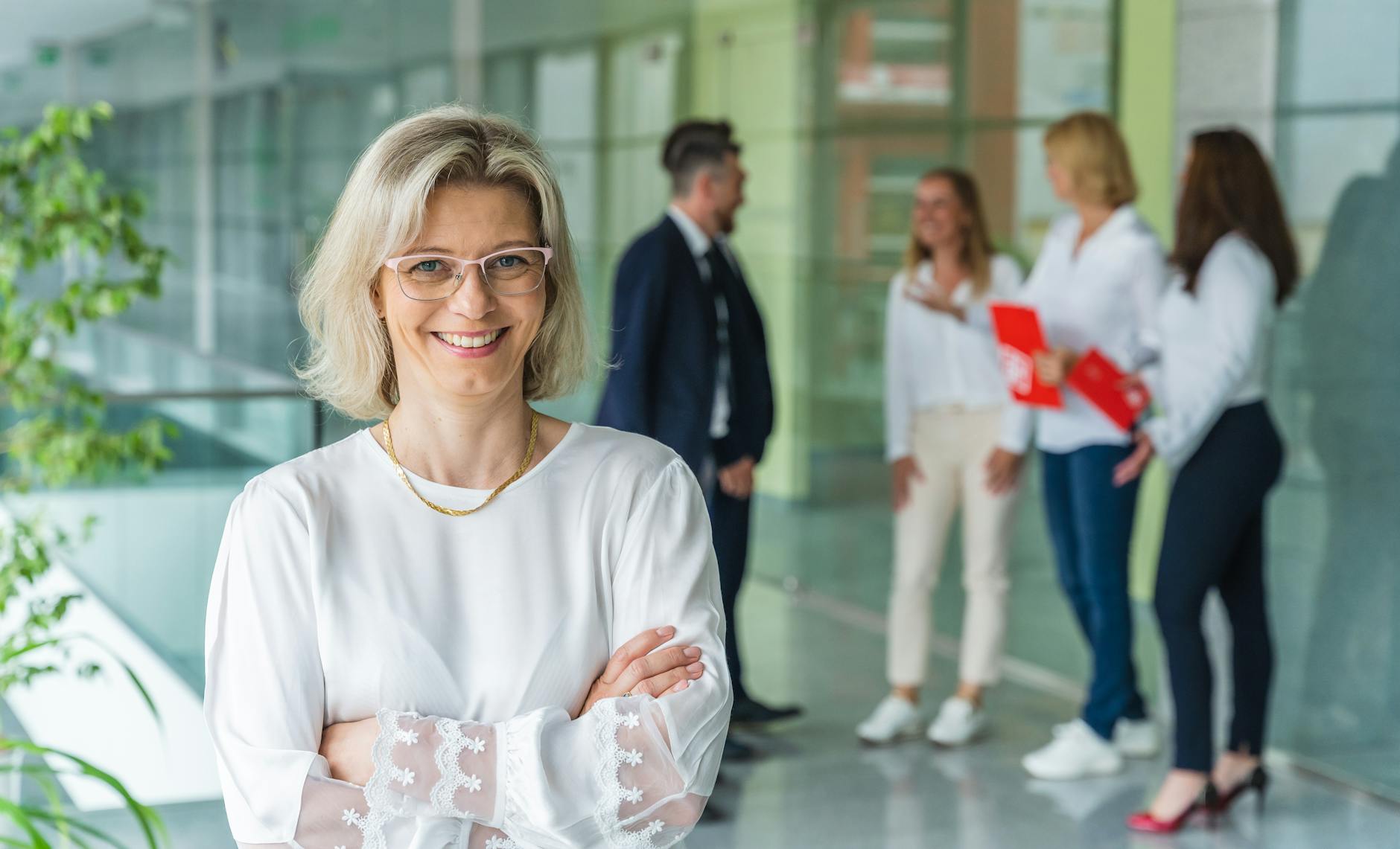 photo of a woman wearing eyeglasses and a white blouse